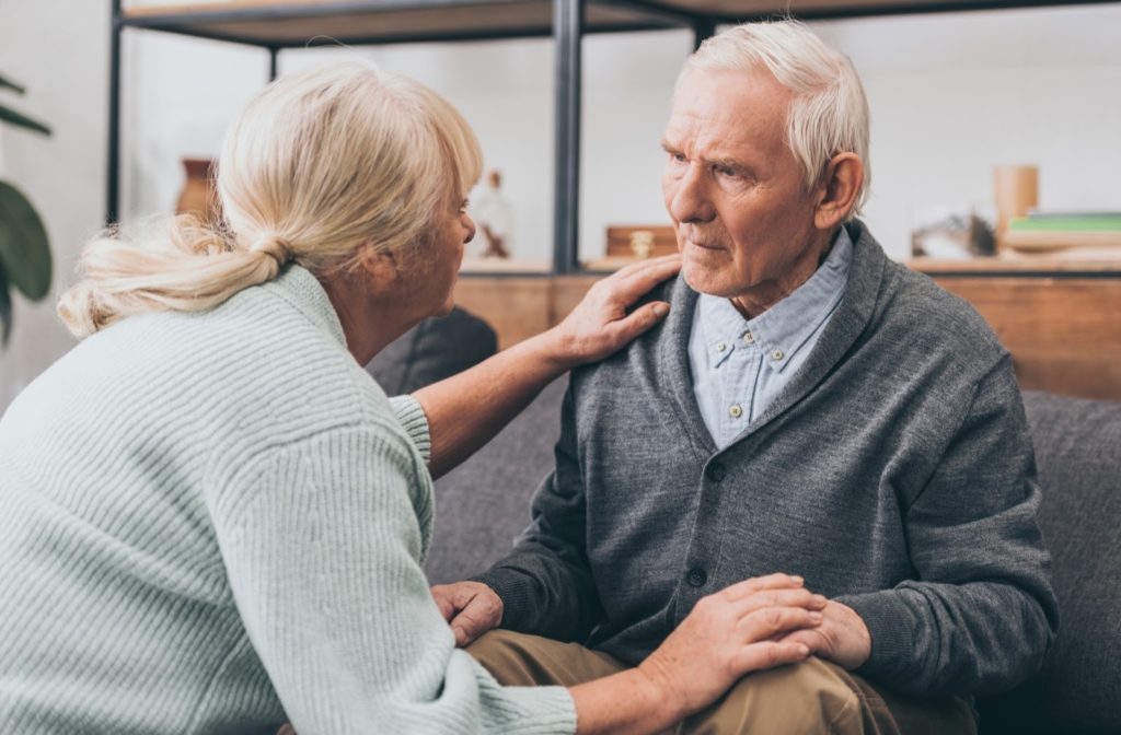 Senior couple sitting together concerned about Alzheimers.