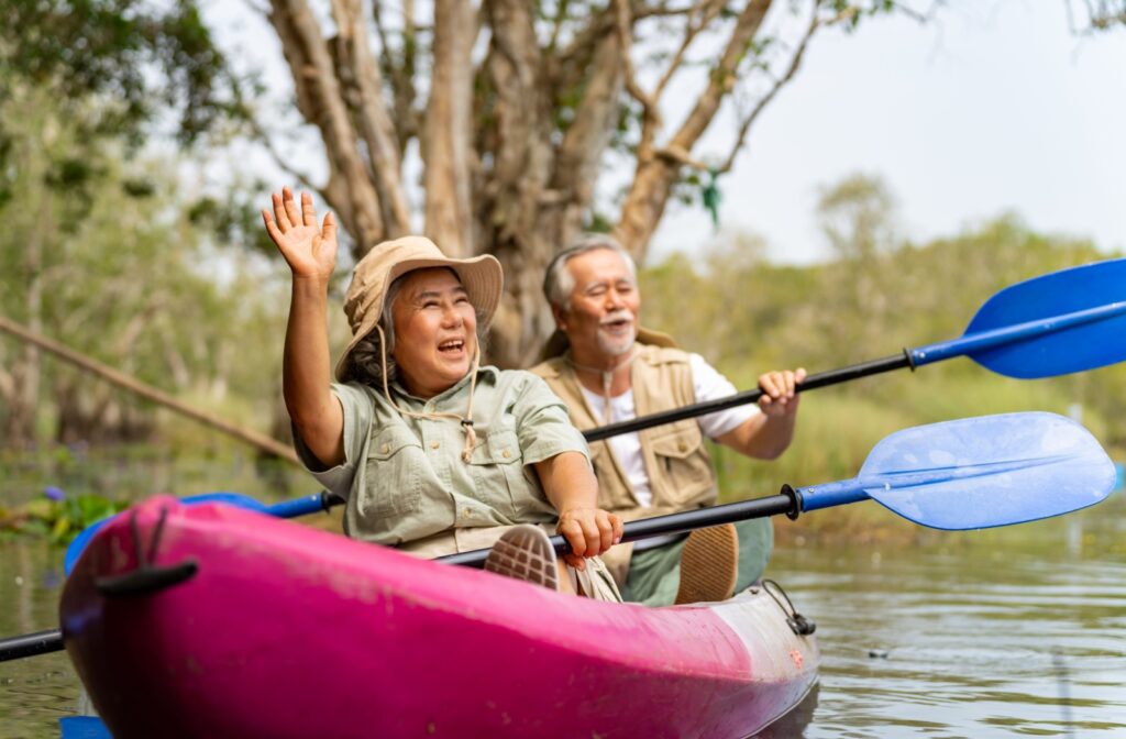 Retired couple enjoying kayaking together on a lake
