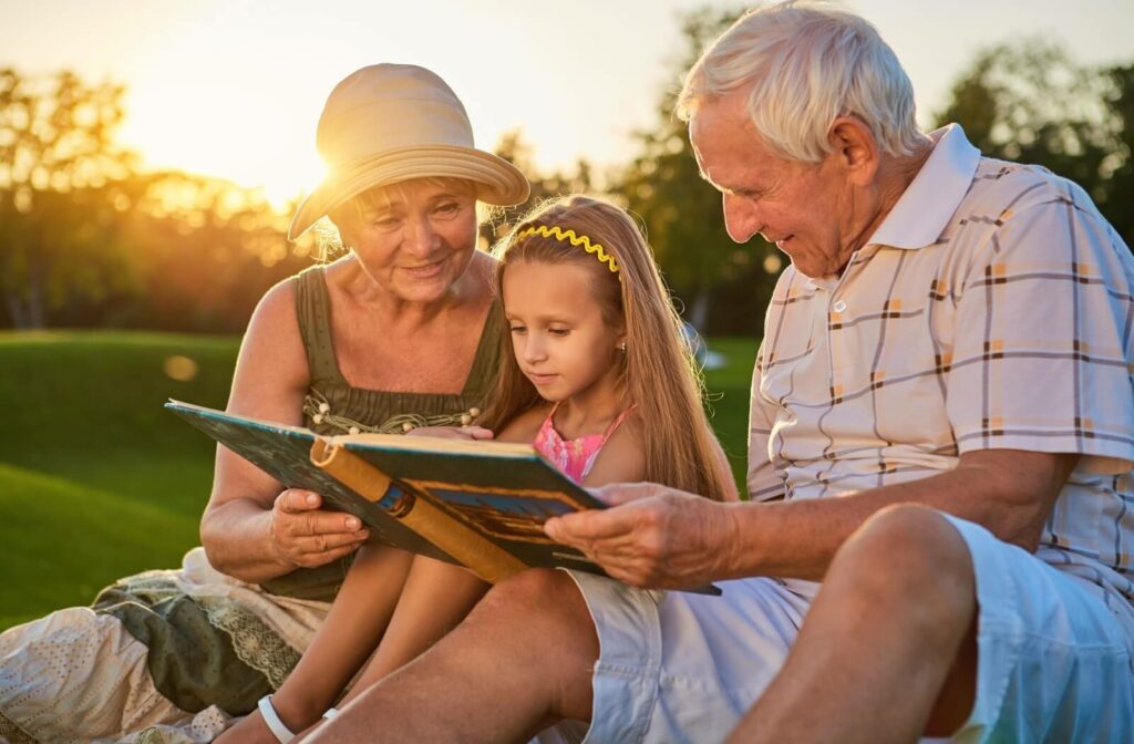 A small girl enjoying her time in the park with her grandparents.