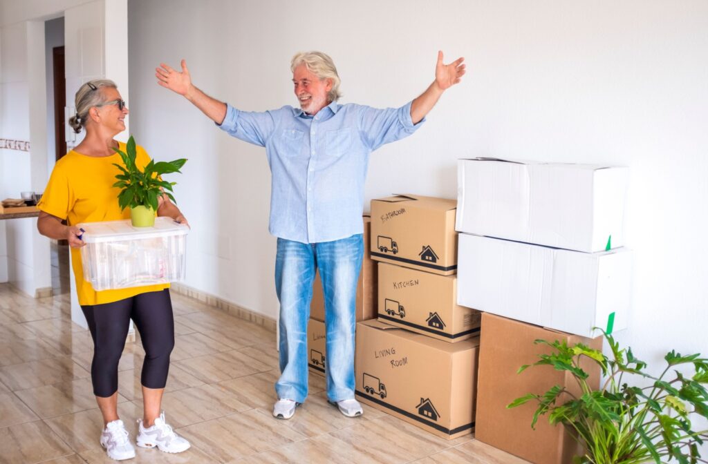 A senior couple celebrate having the majority of their possessions neatly packed away for downsizing for assisted living